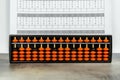 Abacus for mental arithmetic on background of sheet of paper with examples for calculation. Royalty Free Stock Photo