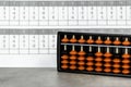 Abacus for mental arithmetic on background of sheet of paper with examples for calculation. Royalty Free Stock Photo