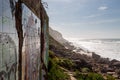 Abadoned wall on ocean coast, view on water. Wind power.