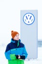 ABAKAN, RUSSIA - JANUARY 3, 2016. Man standing in front of VW dealership sign Royalty Free Stock Photo