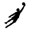 silhouette of a male soccer goalkeeper jump to reach ball.