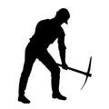 silhouette of a worker swinging his mattock tool.