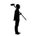 silhouette of a male construction worker digging ground with a shovel.