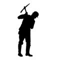 silhouette of a worker swinging his mattock tool.