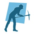 silhouette of a female labour wearing safety helmet holding pick mattock axe.