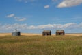 Abandond farm buildings sitting in the praire with a grain silo Royalty Free Stock Photo