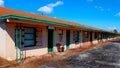 Abandonded Old Motel single row on the side of a busy road Royalty Free Stock Photo