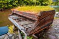 Abandoned aged grand piano covered in the grass near the Vilnia River, Vilnius, Lithuania Royalty Free Stock Photo