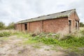 Abandoned agricultural red brick outbuilding