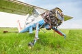 Abandoned aircraft plane standing in the field against cloudy blue sky. Small propeller plane at the airplane cemetery. Royalty Free Stock Photo