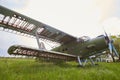 Abandoned aircraft plane standing in the field against cloudy blue sky. Small propeller plane at the airplane cemetery. Royalty Free Stock Photo