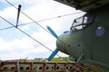 Abandoned aircraft plane standing in the field against cloudy blue sky. Small propeller plane at the airplane cemetery. Royalty Free Stock Photo