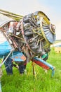 Abandoned aircraft plane standing in the field against cloudy blue sky. Small propeller plane at the airplane cemetery. Royalty Free Stock Photo