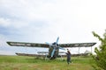 Abandoned aircraft plane standing in the field against cloudy blue sky. Small propeller plane at the airplane cemetery. Royalty Free Stock Photo