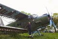 Abandoned aircraft plane standing in the field against cloudy blue sky. Small propeller plane at the airplane cemetery. Royalty Free Stock Photo