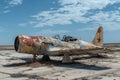 An abandoned airplane, covered in rust, sits motionless on top of a dry grass field, An old rusty fighter aircraft forgotten in a