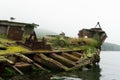 Abandoned antique old wooden ship at sea tropical landscape surrounded by fog Royalty Free Stock Photo