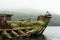 Abandoned antique old wooden ship at sea tropical landscape surrounded by fog Royalty Free Stock Photo