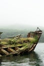 Abandoned antique old wooden ship at sea tropical landscape surrounded by fog Royalty Free Stock Photo