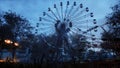 Abandoned Apocalyptic Ferris wheel and carousel in an amusement Park in a city deserted after the Apocalypse. 3D