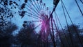 Abandoned Apocalyptic Ferris wheel and carousel in an amusement Park in a city deserted after the Apocalypse. 3D