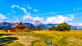 An abandoned Barn at Mormon Row with in the background cloud covered Peaks of the Grand Tetons In Grand Tetons National Park Royalty Free Stock Photo