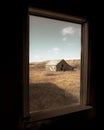 Abandoned barn is seen from a window in the Albertan Badlands, Canada