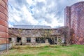 Abandoned barn with silo under stormy clouds Royalty Free Stock Photo