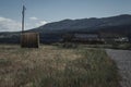 Abandoned Barn Next to Rolled Hay Bale Royalty Free Stock Photo