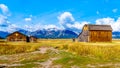 Abandoned Barns at Mormon Row with in the background cloud covered Peaks of the Grand Tetons In Grand Tetons National Park