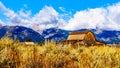 Abandoned Barns at Mormon Row with in the background cloud covered Peaks of the Grand Tetons In Grand Tetons National Park Royalty Free Stock Photo