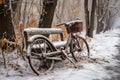 abandoned bicycle by a snow-blanketed bench in the park