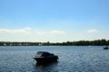 An abandoned boat, anchored slightly off the shore