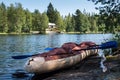 Abandoned boat and paddles on the shore