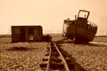 Abandoned boat, rail track and hut on beach