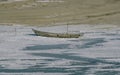 Abandoned boat sits alone on a frozen lake, untouched and desolate Royalty Free Stock Photo