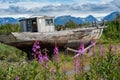 Abandoned boat sits in a junkyard along Alaska Homer Spit on a sunny summer day