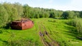 The abandoned bow of the rusty iron large ship - the rest of the industry of the Soviet Union in the wild forests.