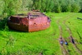Abandoned bow of the rusty iron ship - the rest of the industry of the Soviet Union in the wild forests of the tundra of Yakutia