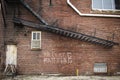 Abandoned brick building with metal staircase