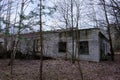 Abandoned brick buildings among trees in the Chernobyl radiation contamination zone