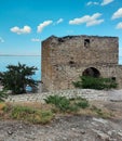 Abandoned brick docks overgrown with moss. An ancient ruined building on the pier. Royalty Free Stock Photo