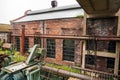 Abandoned brick industrial building on a rainy day