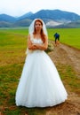 Abandoned bride and groom running away on a bike - funny wedding concept. Royalty Free Stock Photo