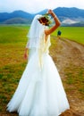 Abandoned bride and groom running away on a bike - funny wedding concept. Royalty Free Stock Photo