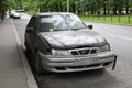 Abandoned broken car on city street