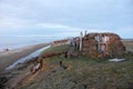 Abandoned broken mud hut at arctic island summer calm sea coast