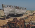 Abandoned broken rusty boat in a desert area under a clear sky Royalty Free Stock Photo