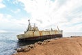 Abandoned broken ship-wreck beached on rocky sea shore. Royalty Free Stock Photo