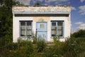 Abandoned building of a closed grocery store with grassed stairs in Topilly railway station of Ryazan region, Russia. Royalty Free Stock Photo